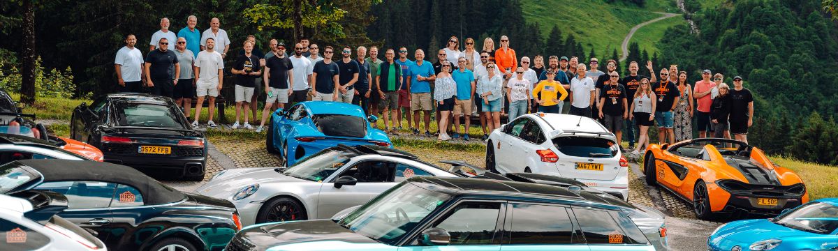 group of Rico Rally friends pose for a photo with their cars on the Hahntennjoch pass