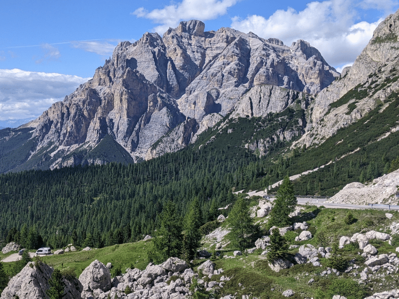 View of the Dolomites and a mountain road on Rico Rally